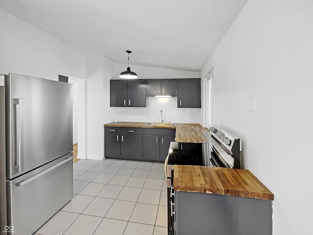 2928 Sheffield Dr, Indianapolis, IN 46229 - kitchen featuring appliances with stainless steel finishes, butcher block counters, vaulted ceiling, a sink, and light tile patterned floors