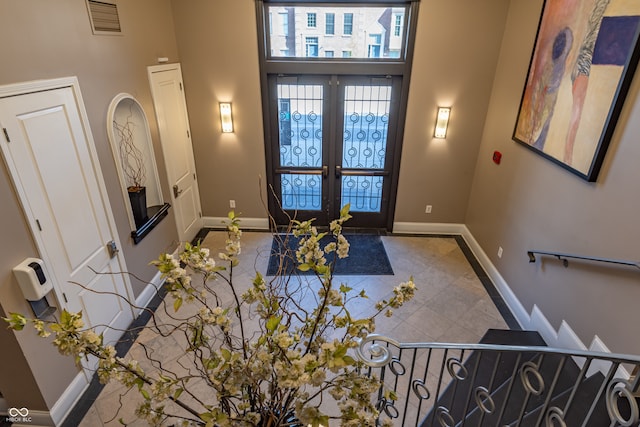 entryway featuring baseboards, visible vents, french doors, and tile patterned floors