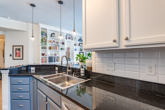 kitchen featuring open shelves, ornamental molding, hanging light fixtures, a sink, and a peninsula