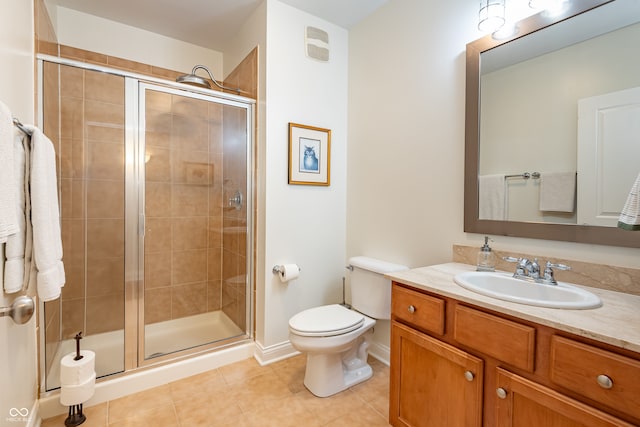 full bath featuring vanity, toilet, baseboards, a shower stall, and tile patterned floors