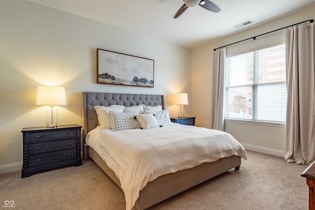 bedroom with baseboards, ceiling fan, visible vents, and light carpet