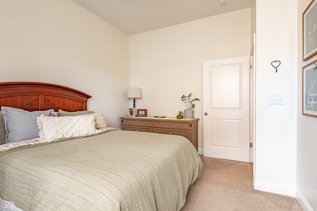bedroom featuring baseboards and light carpet