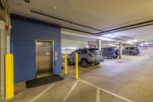 parking deck featuring concrete block wall