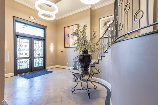 tiled entryway featuring baseboards, stairs, ornamental molding, and french doors