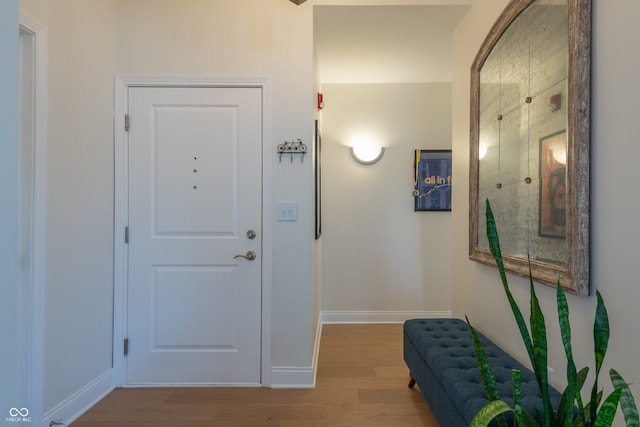 entryway featuring baseboards and light wood-style flooring