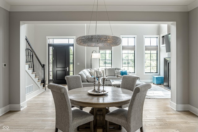 12099 Sigillary Way, Carmel, IN 46032 - dining space featuring light wood-style flooring and stairway