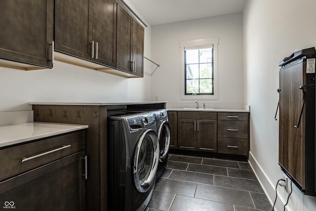 12099 Sigillary Way, Carmel, IN 46032 - washroom featuring cabinet space, independent washer and dryer, and dark tile patterned floors