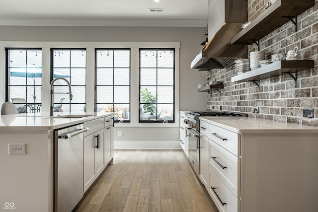 12099 Sigillary Way, Carmel, IN 46032 - kitchen with open shelves, appliances with stainless steel finishes, light countertops, white cabinetry, and ornamental molding