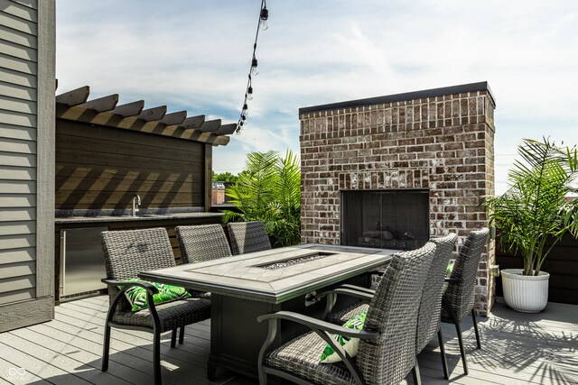 12099 Sigillary Way, Carmel, IN 46032 - wooden terrace featuring outdoor dining space and a brick fireplace