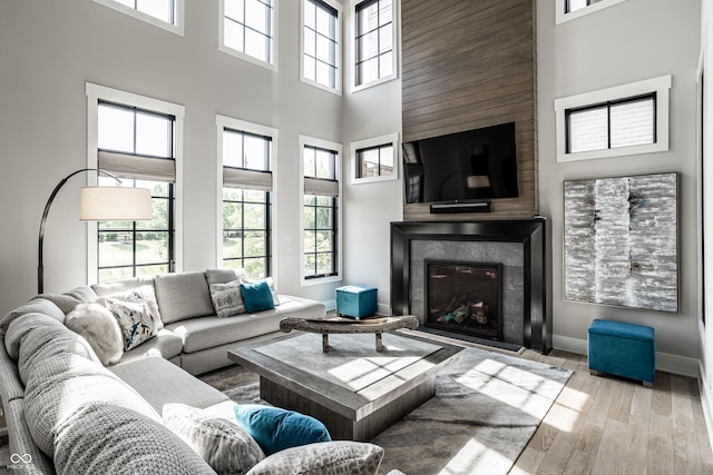 12099 Sigillary Way, Carmel, IN 46032 - living room featuring a high ceiling, wood finished floors, and a tile fireplace