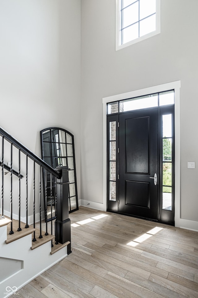 12099 Sigillary Way, Carmel, IN 46032 - entryway with a towering ceiling, wood finished floors, stairs, and plenty of natural light