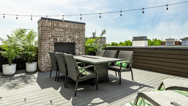 12099 Sigillary Way, Carmel, IN 46032 - wooden deck with an outdoor brick fireplace and outdoor dining space