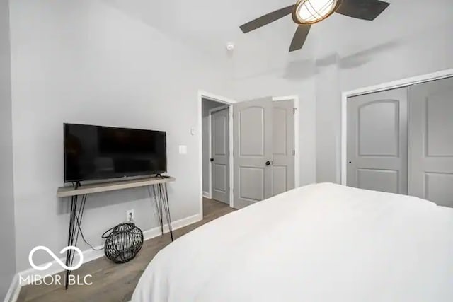 1444 English Ave, Indianapolis, IN 46201 - bedroom with dark wood-style flooring, a closet, baseboards, and ceiling fan