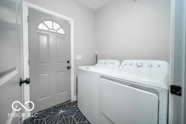 1444 English Ave, Indianapolis, IN 46201 - washroom with dark tile patterned floors, washing machine and dryer, and laundry area