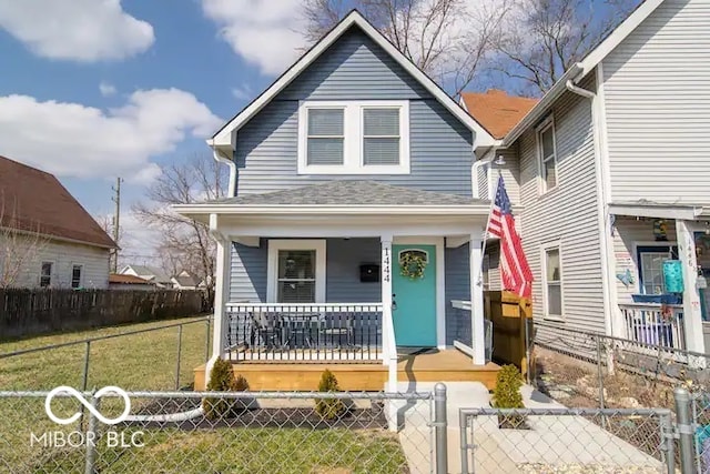 1444 English Ave, Indianapolis, IN 46201 - view of front of house with a gate, covered porch, a front lawn, and a fenced front yard
