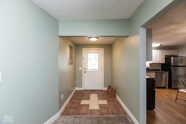 251 Howard Rd, Greenwood, IN 46142 - doorway with baseboards and a textured ceiling