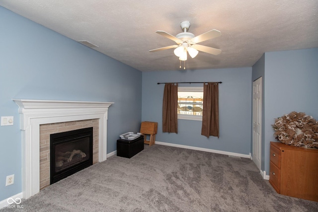 251 Howard Rd, Greenwood, IN 46142 - unfurnished living room featuring a textured ceiling, baseboards, a fireplace, a ceiling fan, and carpet floors