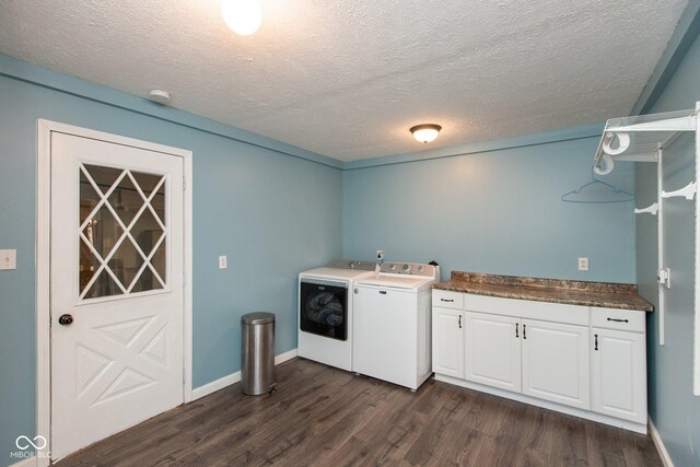 251 Howard Rd, Greenwood, IN 46142 - clothes washing area featuring a textured ceiling, dark wood-style floors, baseboards, washer and dryer, and cabinet space