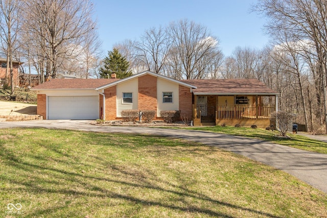 251 Howard Rd, Greenwood, IN 46142 - view of front of home featuring a garage, concrete driveway, a front yard, brick siding, and covered porch