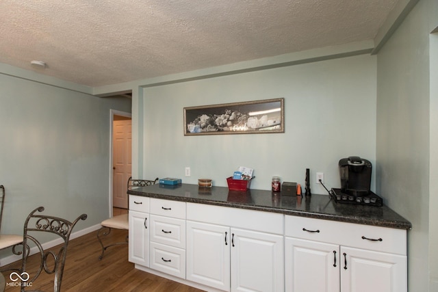 251 Howard Rd, Greenwood, IN 46142 - interior space featuring baseboards, white cabinets, wood finished floors, and a textured ceiling