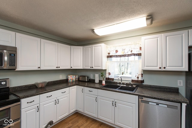 251 Howard Rd, Greenwood, IN 46142 - kitchen with white cabinetry, a sink, and appliances with stainless steel finishes
