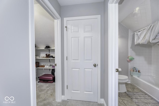 bathroom with toilet and baseboards