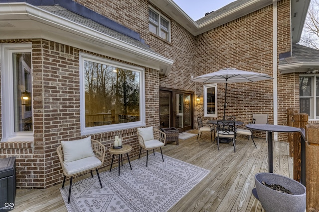 wooden terrace featuring outdoor dining area