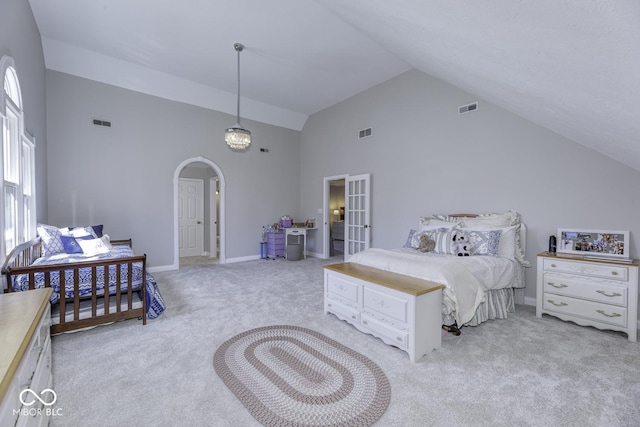 bedroom featuring light carpet, high vaulted ceiling, arched walkways, and visible vents