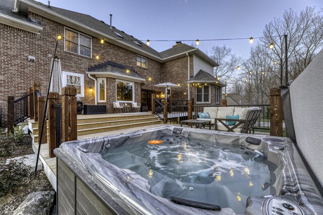 wooden deck with a hot tub