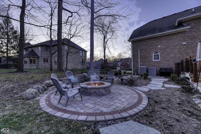 view of yard with an outdoor fire pit, cooling unit, and a patio
