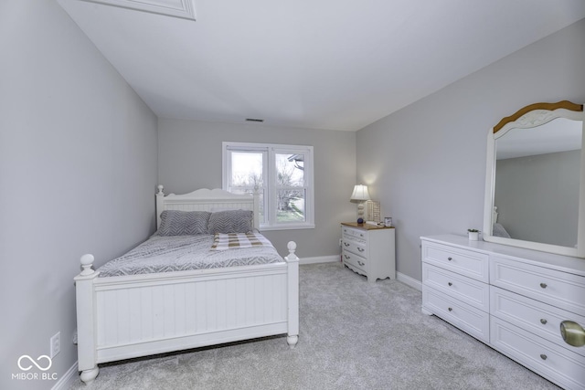 bedroom featuring baseboards, visible vents, and light colored carpet