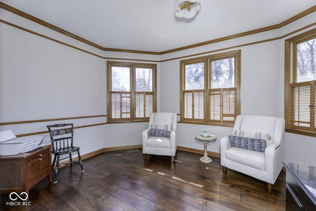 living area with ornamental molding, baseboards, and wood finished floors