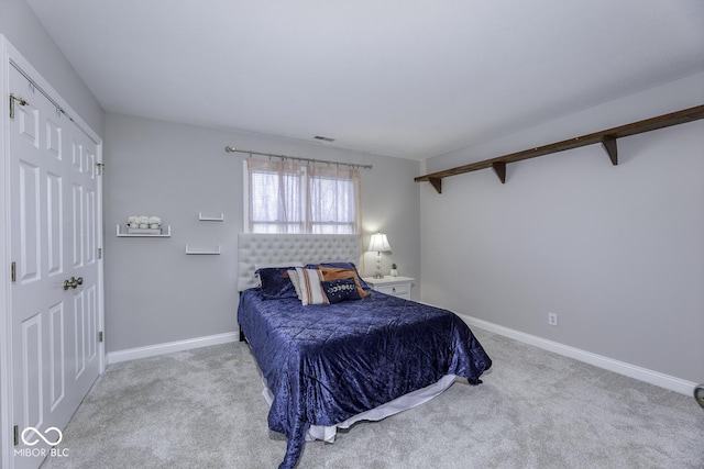 carpeted bedroom featuring baseboards and visible vents