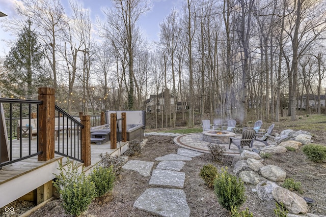 view of yard with an outdoor fire pit, a jacuzzi, and a wooden deck