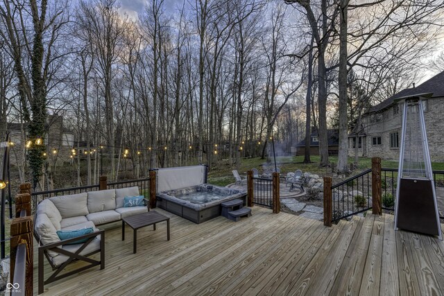 wooden deck with an outdoor hangout area and a hot tub