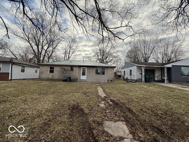 back of house with a lawn and a garage
