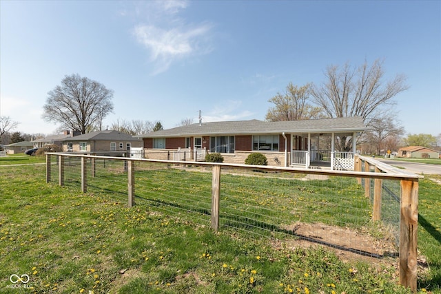 817 Shadowlawn Ave, Greencastle, IN 46135 - view of front of home featuring a porch, fence, a front lawn, and brick siding