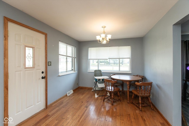 817 Shadowlawn Ave, Greencastle, IN 46135 - dining space with visible vents, light wood-style flooring, a notable chandelier, and baseboards
