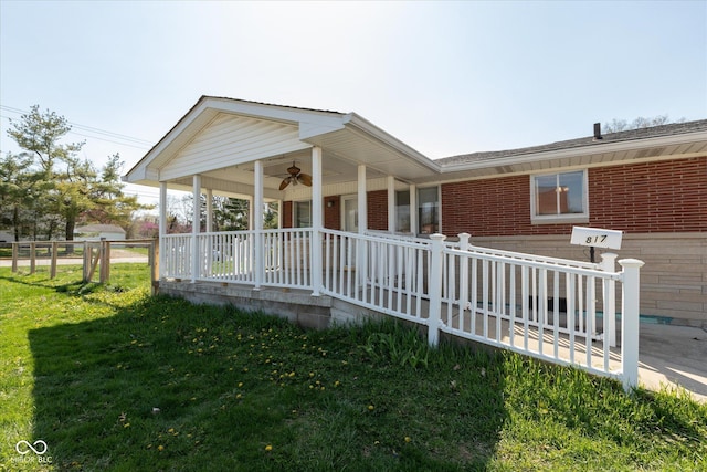 817 Shadowlawn Ave, Greencastle, IN 46135 - view of front facade with brick siding, a front lawn, fence, and covered porch