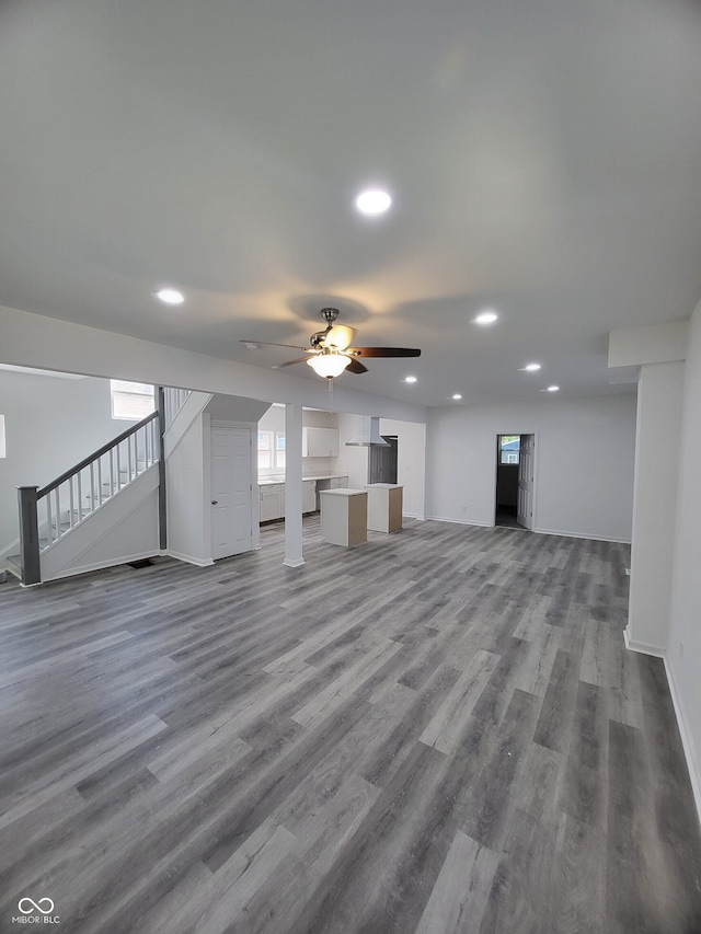 unfurnished living room with stairs, wood finished floors, recessed lighting, and a ceiling fan