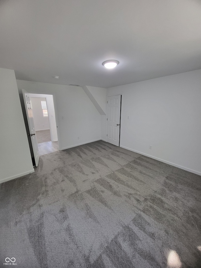 unfurnished room featuring baseboards and carpet floors
