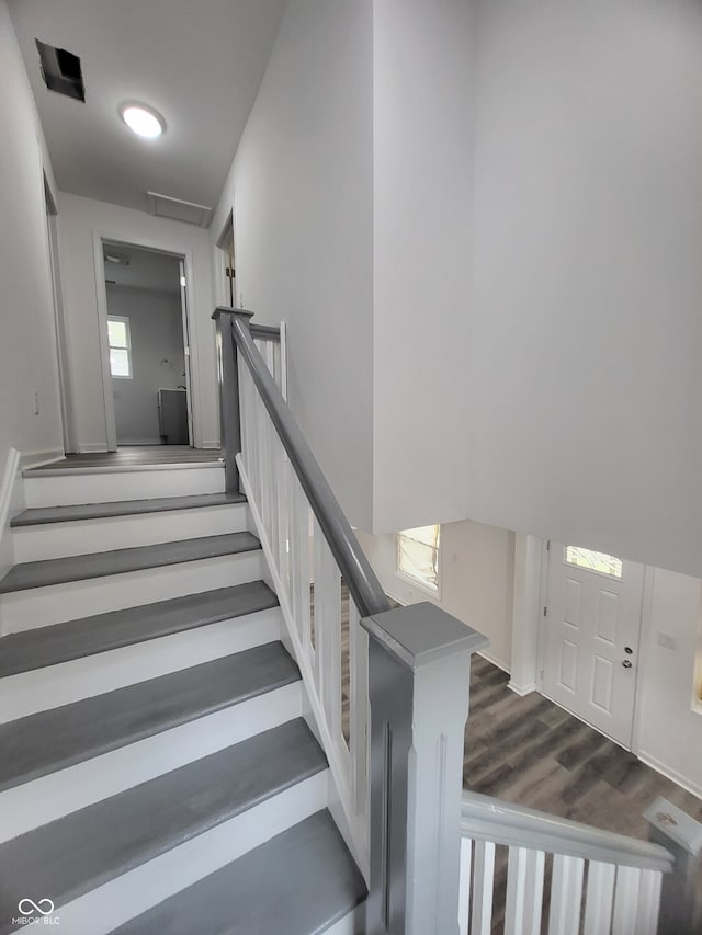stairway featuring wood finished floors