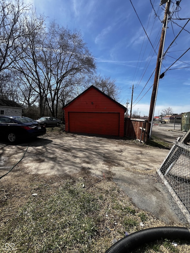 detached garage featuring fence
