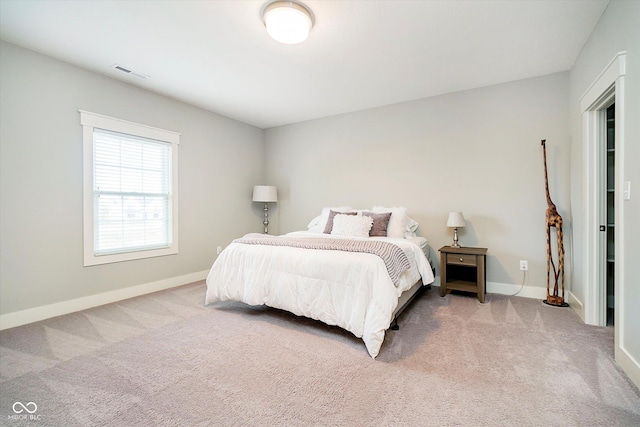 bedroom with light carpet, baseboards, and visible vents