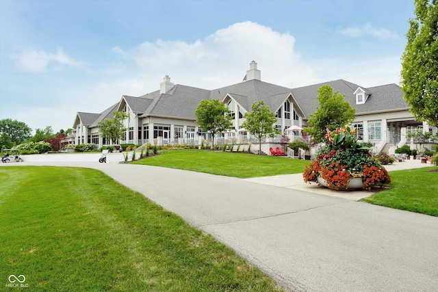 view of front of property featuring a residential view and a front lawn