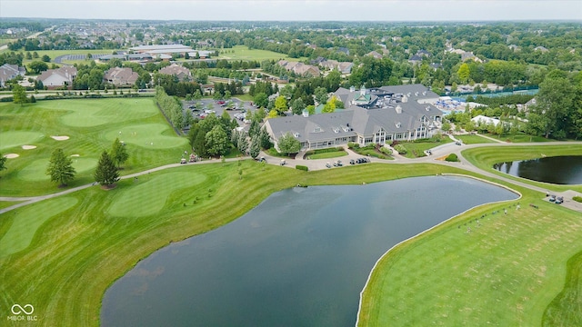 drone / aerial view with view of golf course, a residential view, and a water view