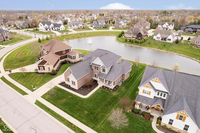 bird's eye view featuring a residential view and a water view
