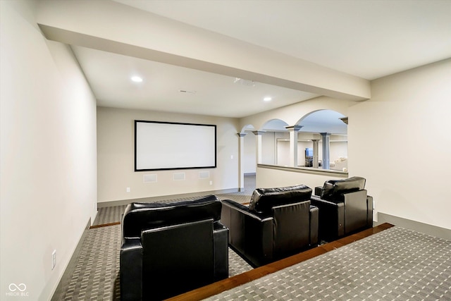 cinema room with arched walkways, baseboards, recessed lighting, and ornate columns