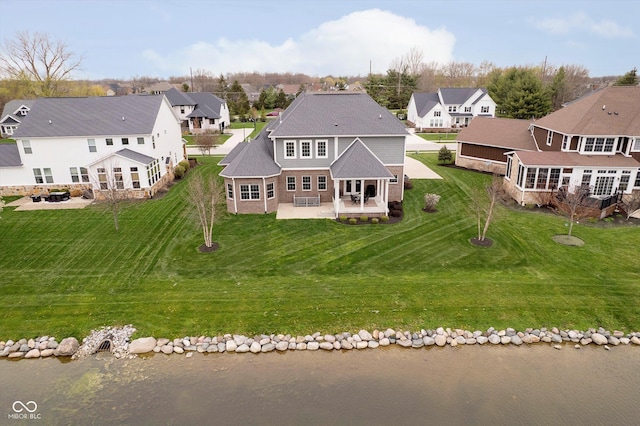 bird's eye view featuring a water view and a residential view