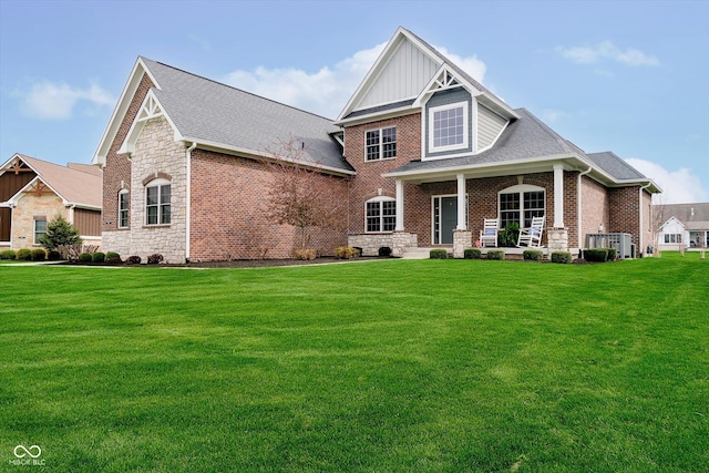 craftsman house featuring board and batten siding, a porch, stone siding, and a front lawn